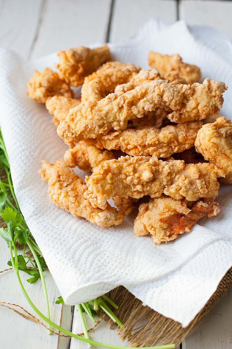 a plate of fried chicken tenders on a paper towel
