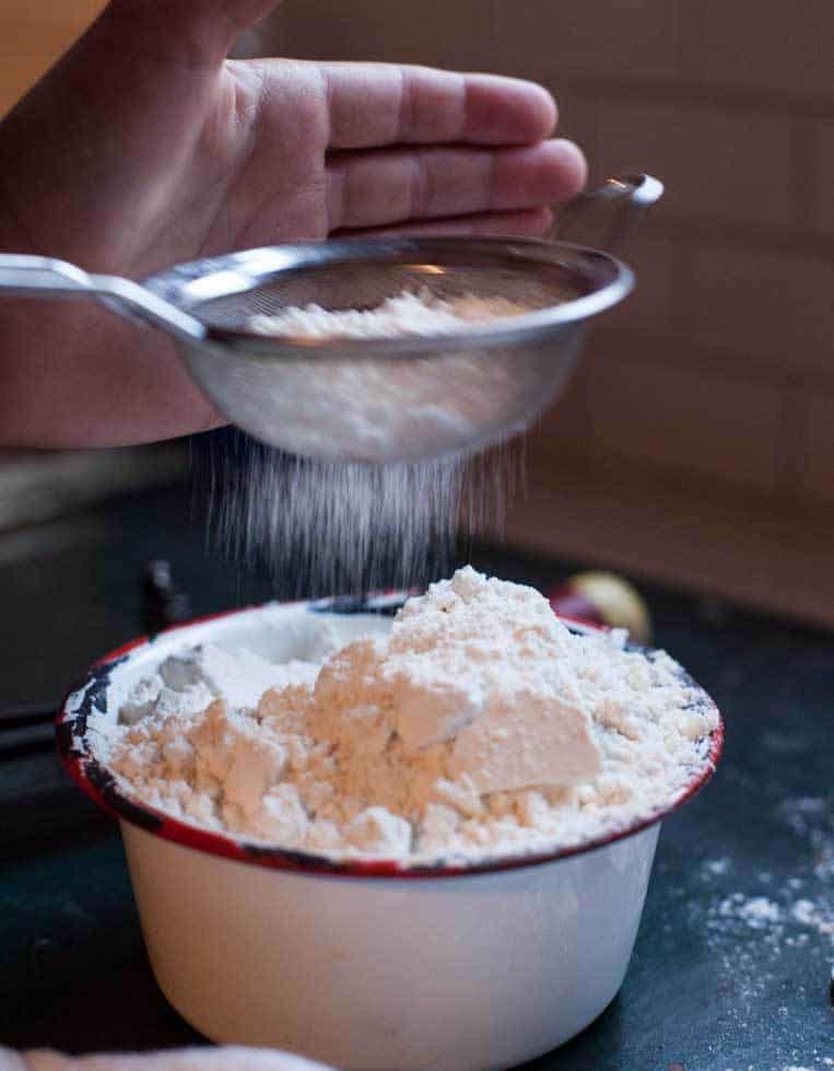a bowl of flour being sifted 