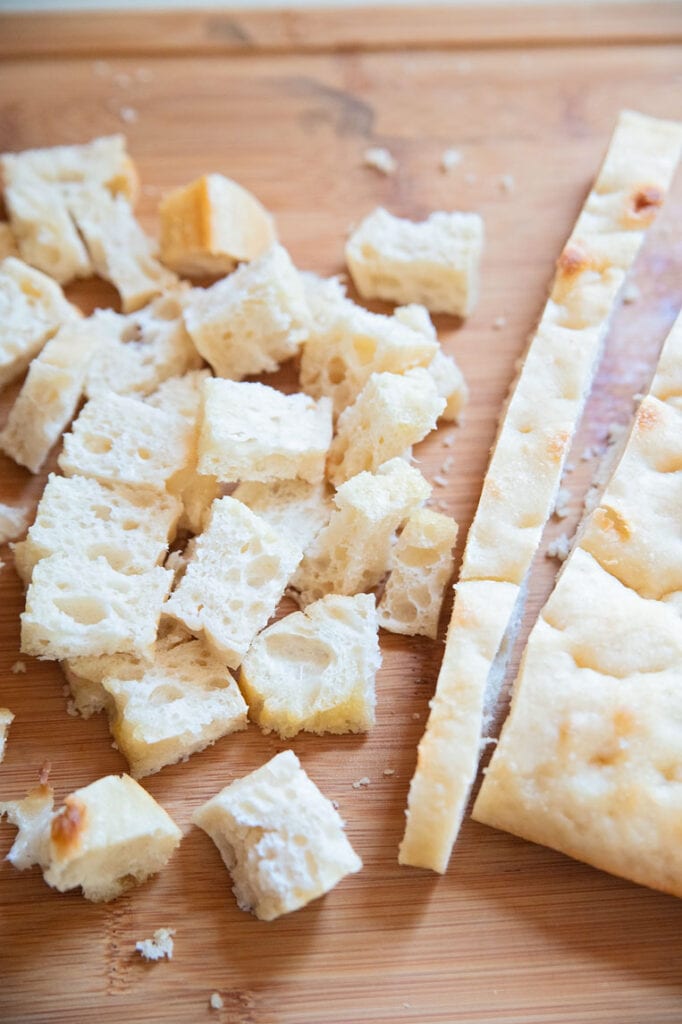 a few cubes of homemade croutons with a slice of bread cut off of the main loaf
