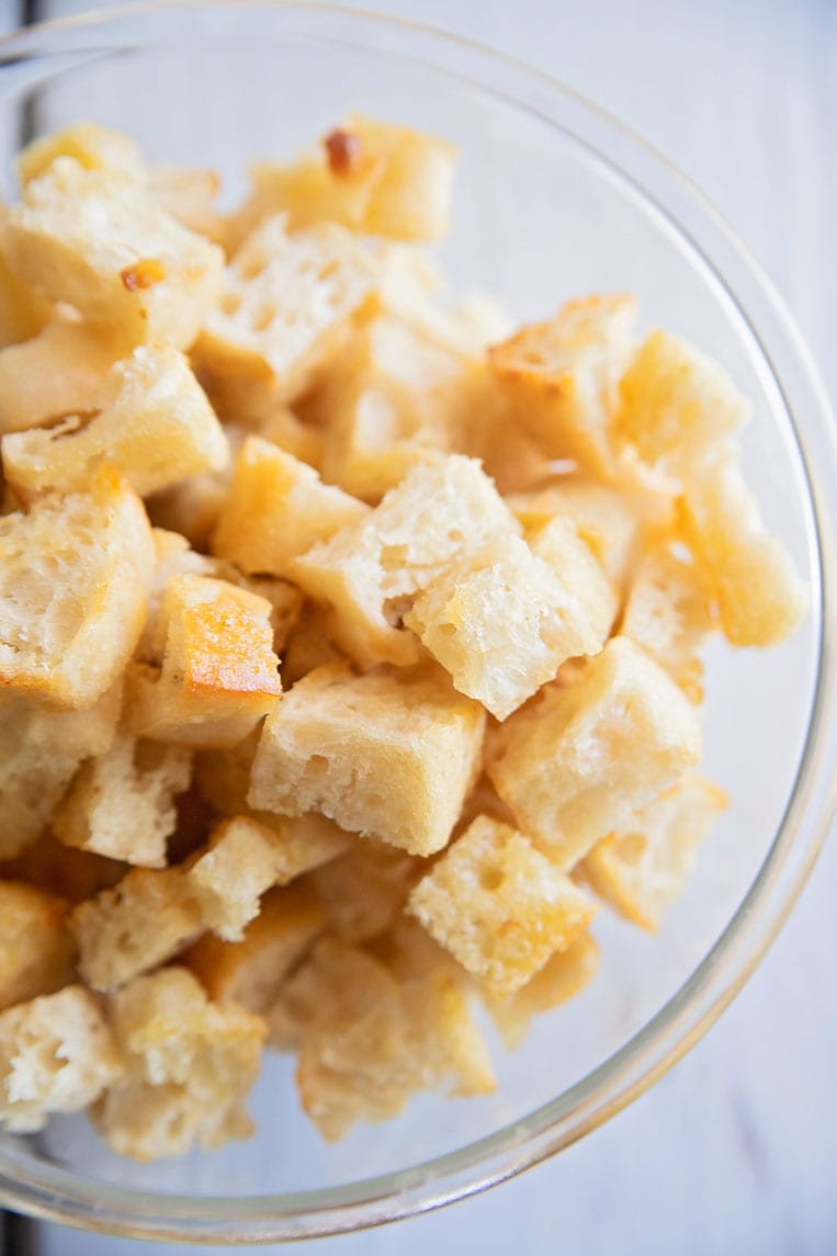 a bowl of golden brown croutons in a bowl