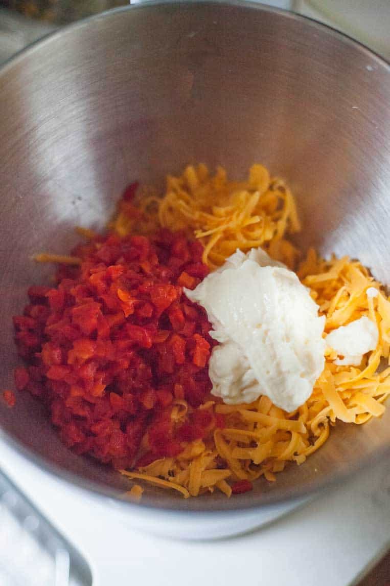 cheddar cheese, pimentos, mayonnaise and seasonings in a bowl 