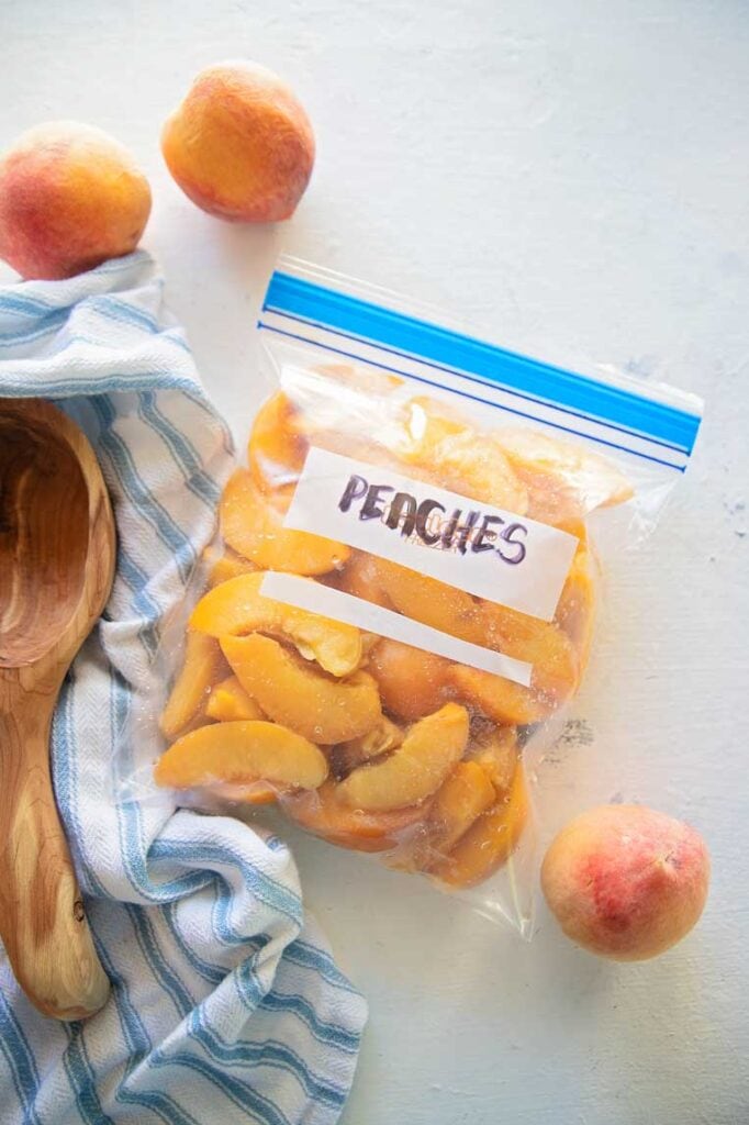 a freezer bag of peaches on a table