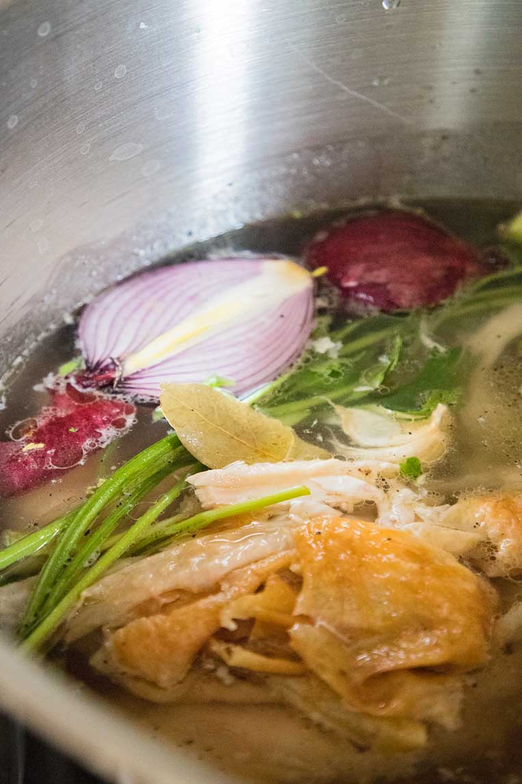 Chicken stock starts with vegetables like carrots, celery and onions and the bones of a roast chicken. 