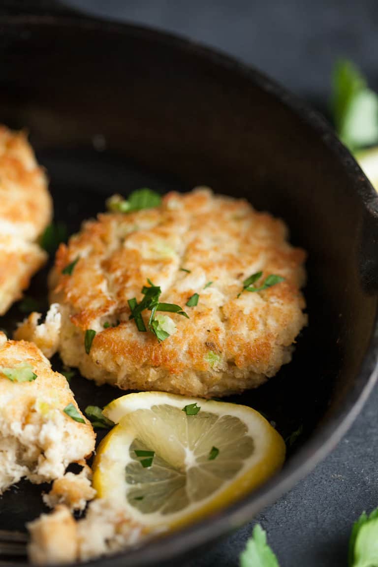 a close up photograph of a crab cake in a skillet