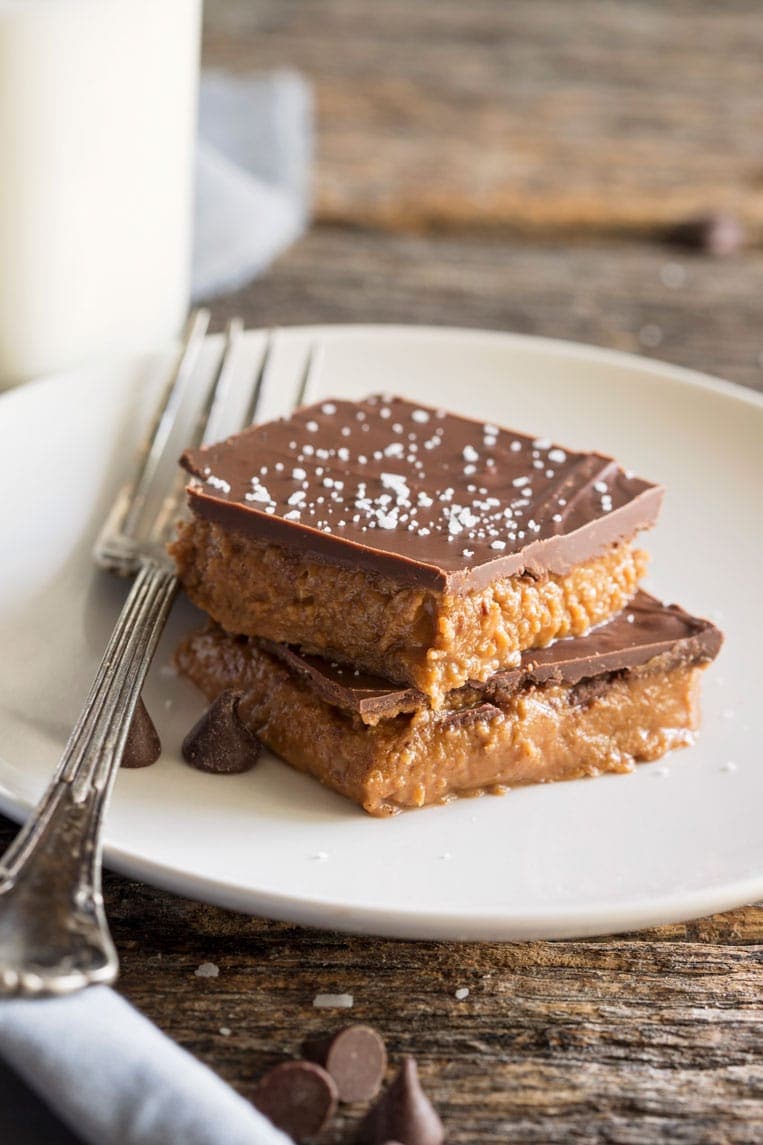 two almond butter bars stacked on top of each other on a plate