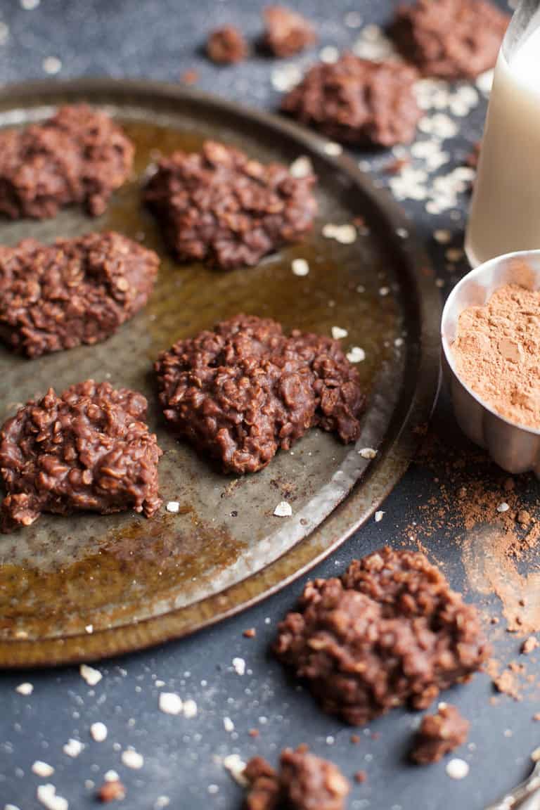 no bake cookies on a pan with milk and cocoa powder on the side