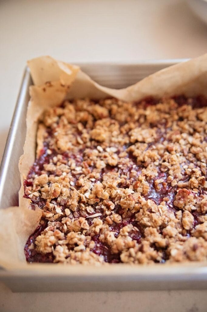 a pan of hot baked raspberry crumble bars cooling in the pan