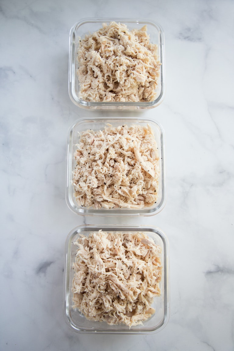 three small glass baking dishes with shredded chicken