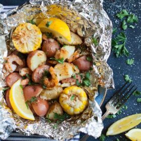 Shrimp, potatoes, corn, and smoked sausage in a foil packet. Old bay shrimp boil packets.