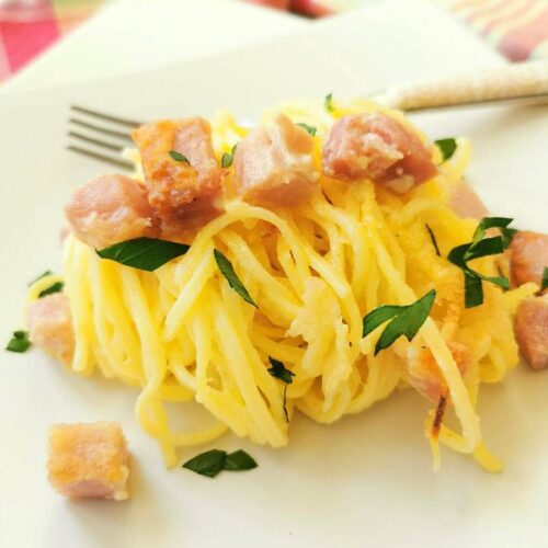 ham and spaghetti on a plate with fork