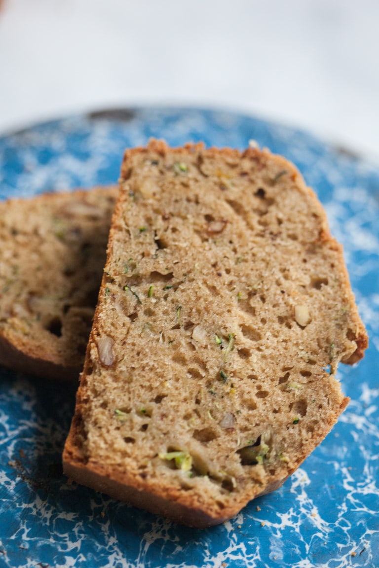 a slice of zucchini bread on a blue plate